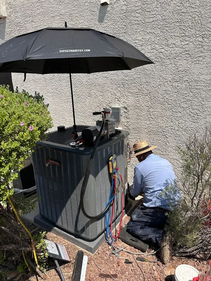 HVAC technician performing outdoor AC maintenance in Mount Pleasant